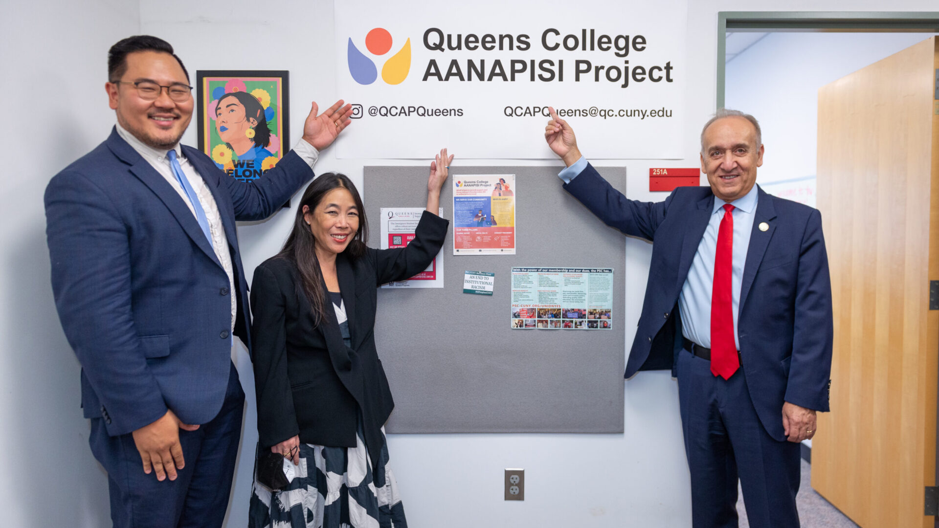 Dr. Paydar and other officials from the White House and USDOE pose in front of the QCAP sign at the student lounge area.